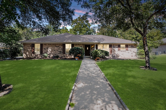 ranch-style house with a yard