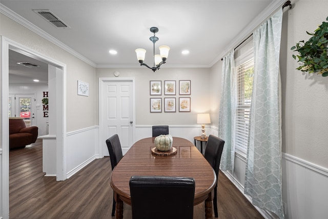 dining space with ornamental molding, an inviting chandelier, and dark wood-type flooring