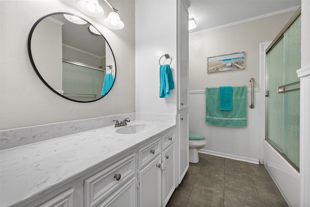 full bathroom with shower / bath combination with glass door, vanity, tile patterned floors, crown molding, and toilet