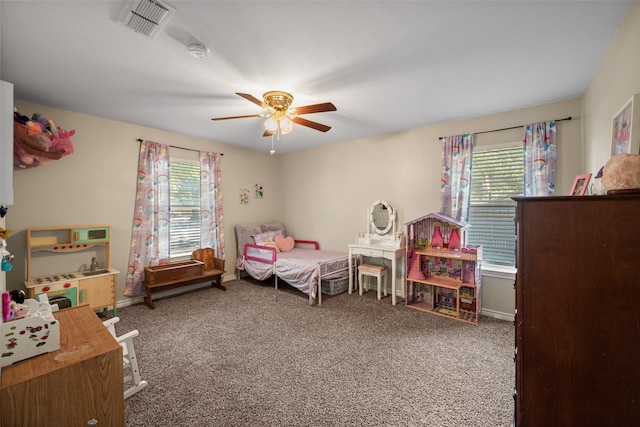 carpeted bedroom featuring ceiling fan and multiple windows