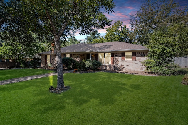 single story home featuring a yard