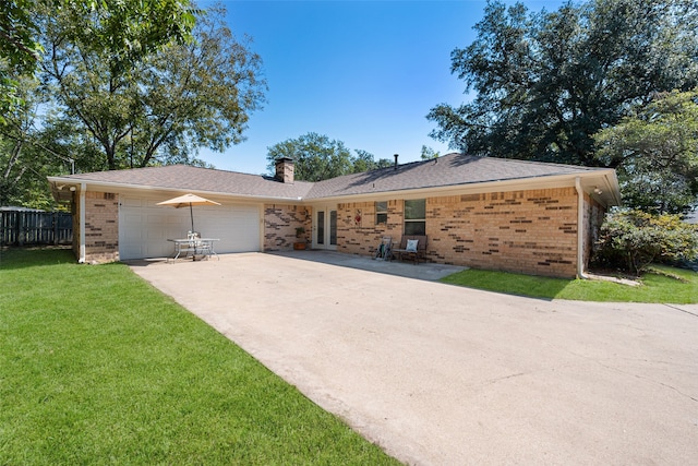 ranch-style home featuring a front yard and a garage