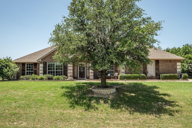 7710 Valley Ridge Dr, Northlake, TX 76247 - view of property hidden behind natural elements with a front lawn, brick siding, and roof with shingles