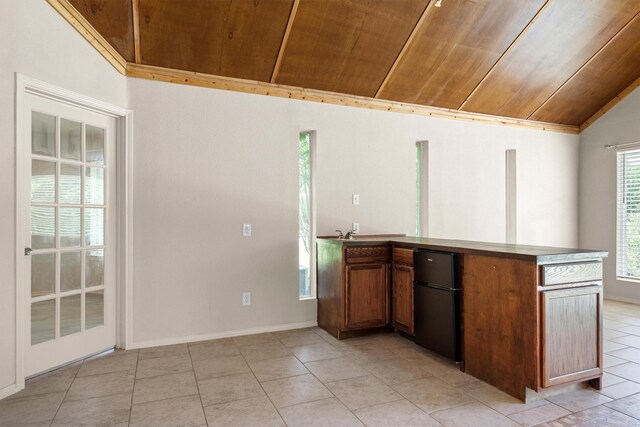 7710 Valley Ridge Dr, Northlake, TX 76247 - kitchen featuring wood ceiling, lofted ceiling, refrigerator, light tile patterned floors, and brown cabinetry