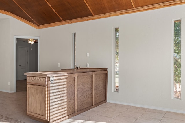 bar with a wealth of natural light, light tile patterned floors, wood ceiling, and vaulted ceiling