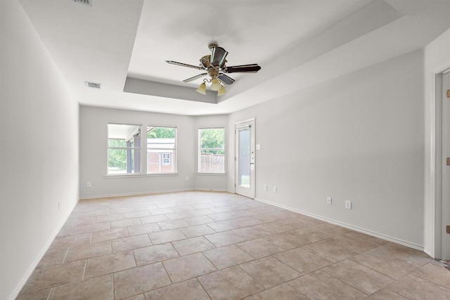7710 Valley Ridge Dr, Northlake, TX 76247 - empty room featuring a ceiling fan, a tray ceiling, and baseboards