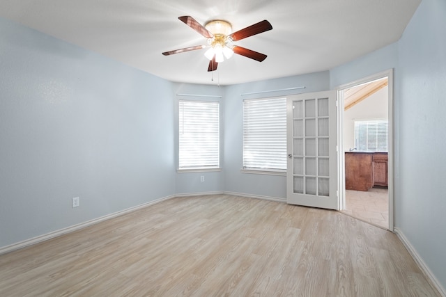 empty room featuring french doors, light hardwood / wood-style floors, plenty of natural light, and ceiling fan