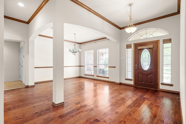 7710 Valley Ridge Dr, Northlake, TX 76247 - foyer featuring arched walkways, wood-type flooring, ornamental molding, a chandelier, and baseboards