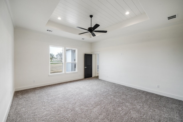 carpeted spare room with ceiling fan, a raised ceiling, crown molding, and wood ceiling