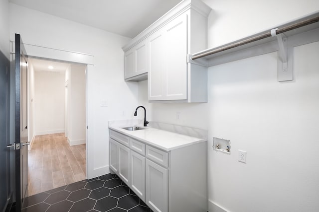 washroom featuring hookup for a washing machine, cabinets, dark hardwood / wood-style floors, and sink