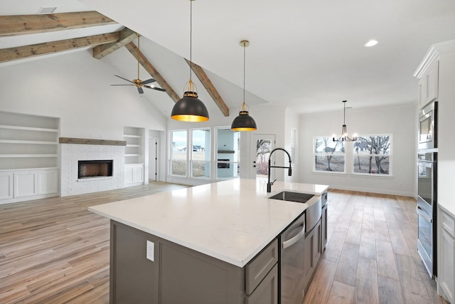 kitchen featuring light wood-type flooring, a wealth of natural light, hanging light fixtures, and white cabinets