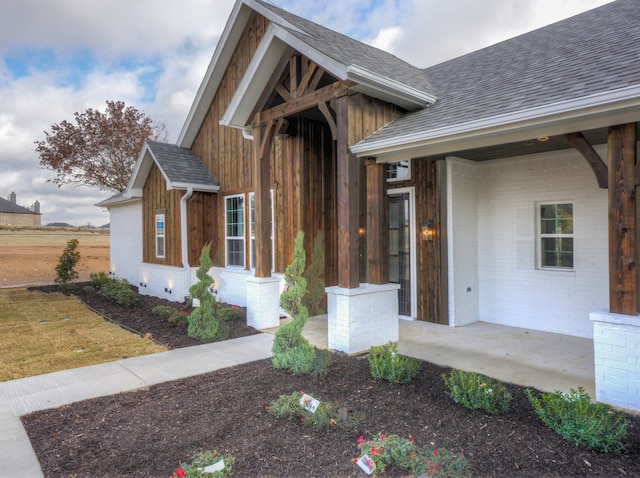 view of exterior entry featuring a porch