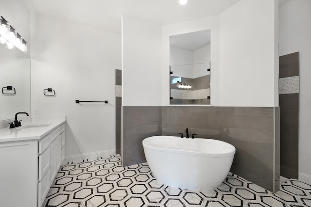 bathroom with vanity, tile walls, plus walk in shower, and tile patterned floors