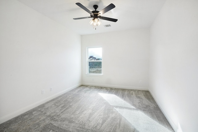 carpeted spare room with ceiling fan