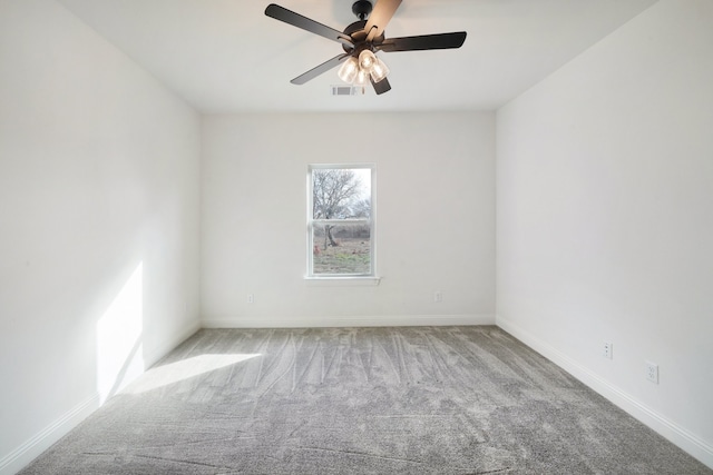 carpeted spare room featuring ceiling fan