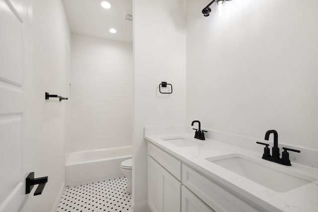 full bathroom featuring washtub / shower combination, vanity, and toilet