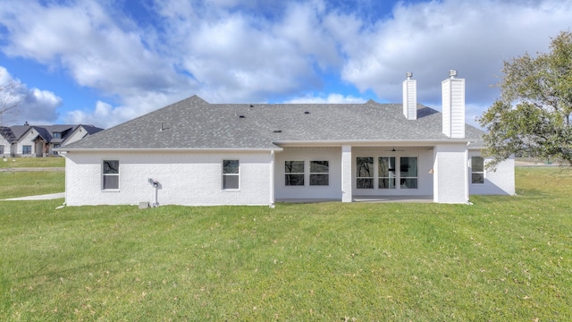 back of house featuring a patio and a yard