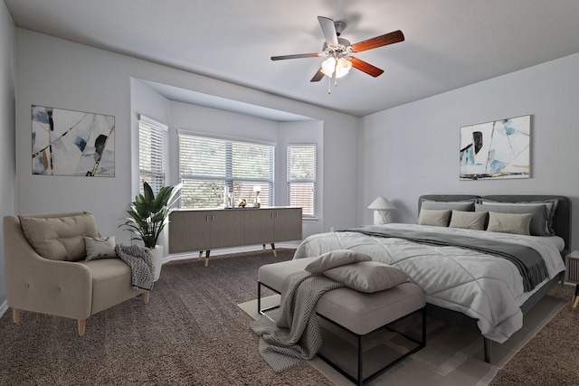 bedroom with dark colored carpet and ceiling fan