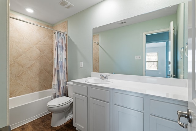 full bathroom featuring vanity, toilet, shower / bathtub combination with curtain, and hardwood / wood-style flooring