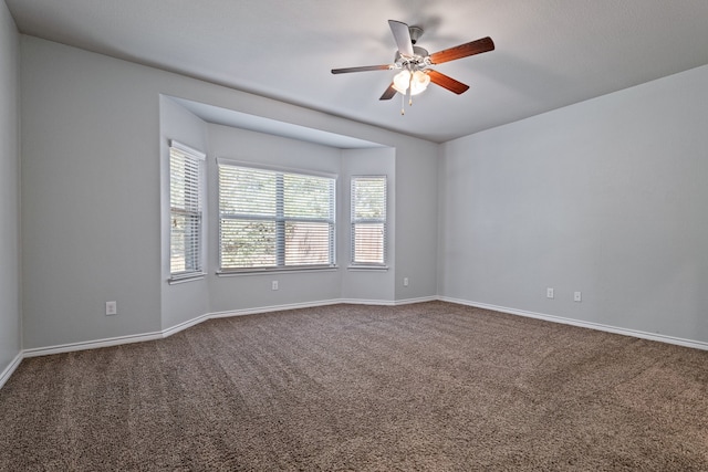 spare room featuring ceiling fan and carpet floors