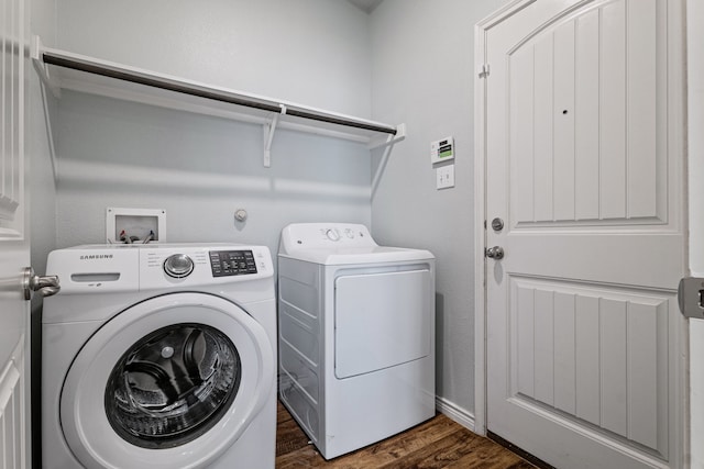 laundry room featuring washer and clothes dryer and dark hardwood / wood-style floors