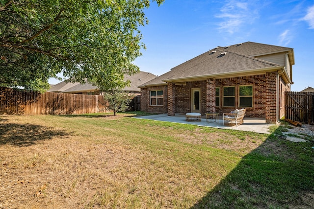 back of house with a lawn and a patio area