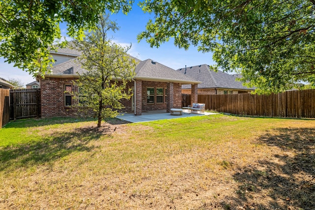 back of property featuring a yard and a patio