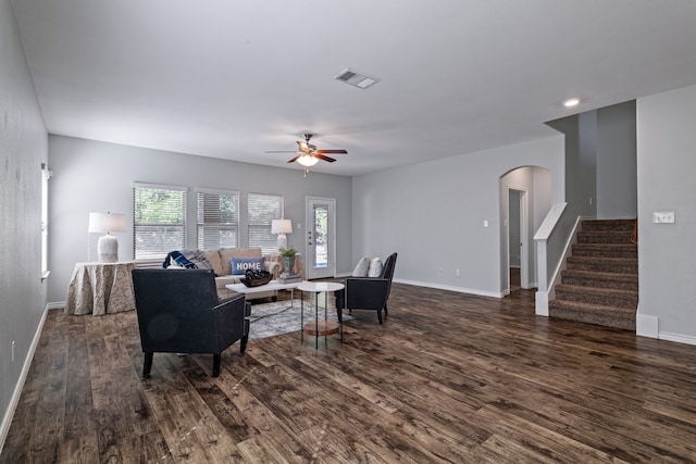 living room with dark hardwood / wood-style floors and ceiling fan