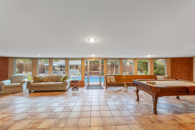 playroom with expansive windows, pool table, and a healthy amount of sunlight