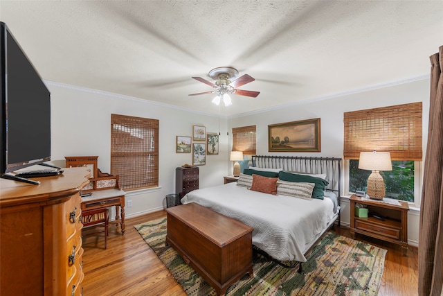 bedroom featuring ornamental molding, hardwood / wood-style floors, and ceiling fan