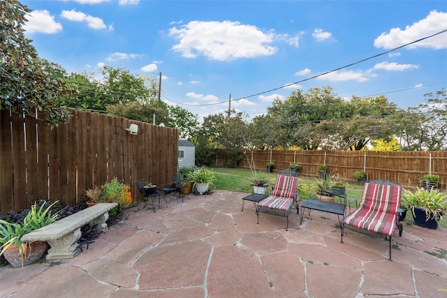 view of patio / terrace with a shed