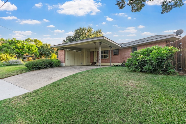 single story home with a front lawn and a carport