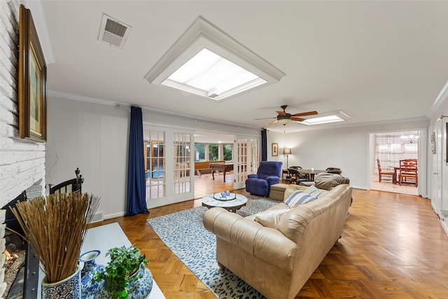 living room with a fireplace, french doors, parquet floors, ceiling fan, and ornamental molding