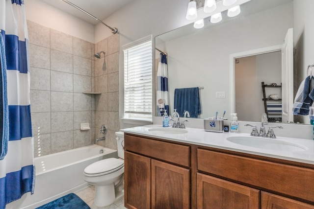 full bathroom with tile patterned floors, toilet, shower / bath combo with shower curtain, and vanity