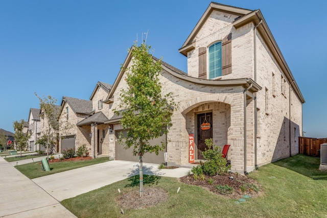 view of front of home featuring a front yard and a garage