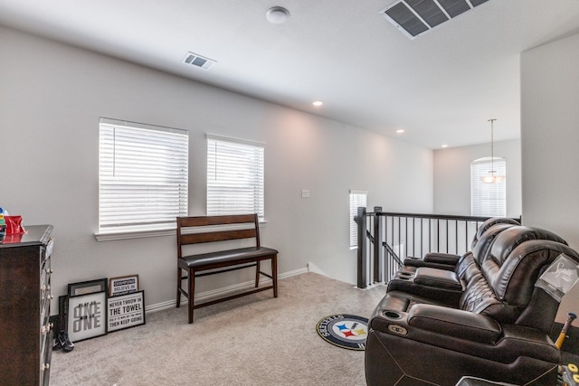 living area with light carpet and a wealth of natural light