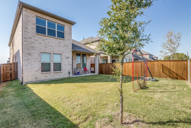 rear view of property featuring a lawn and a patio