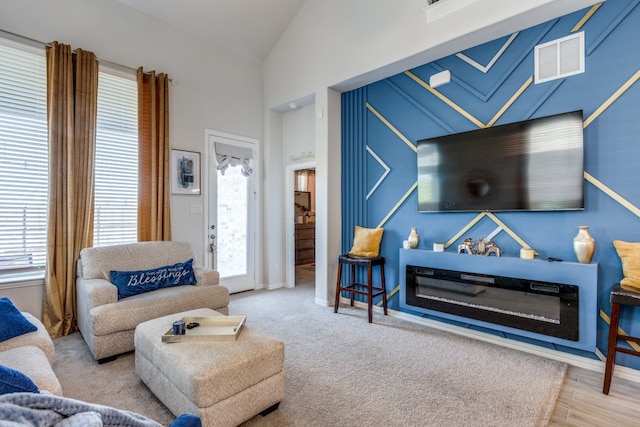 living room featuring light hardwood / wood-style flooring and high vaulted ceiling