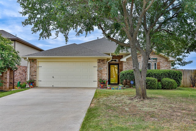 view of front facade featuring a front lawn and a garage