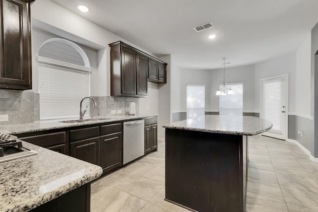 kitchen featuring dark brown cabinets, dishwasher, pendant lighting, a notable chandelier, and sink