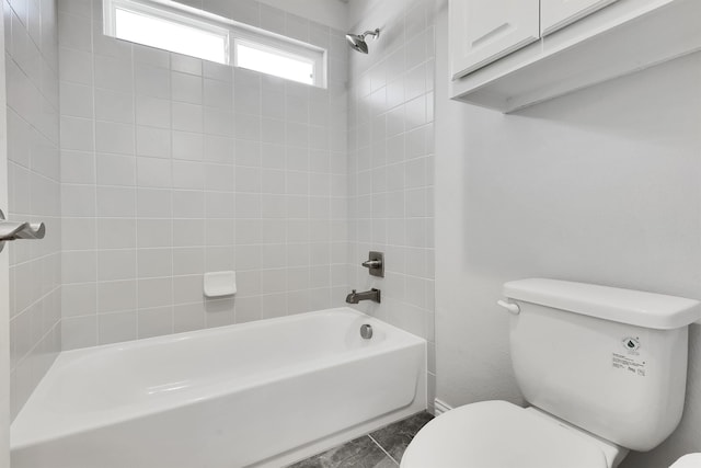 bathroom featuring toilet and tiled shower / bath combo