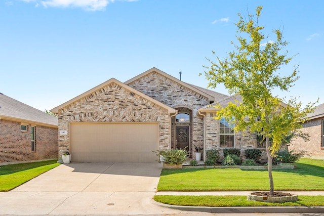 view of front of house with a garage and a front yard