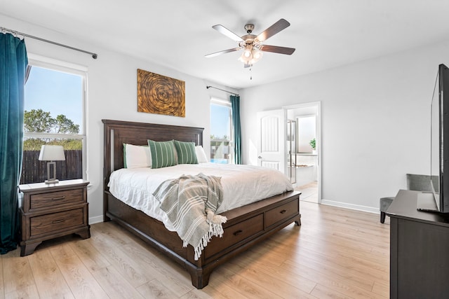 bedroom featuring ceiling fan, connected bathroom, and light hardwood / wood-style flooring