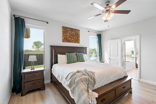 bedroom with ceiling fan, connected bathroom, and light hardwood / wood-style floors