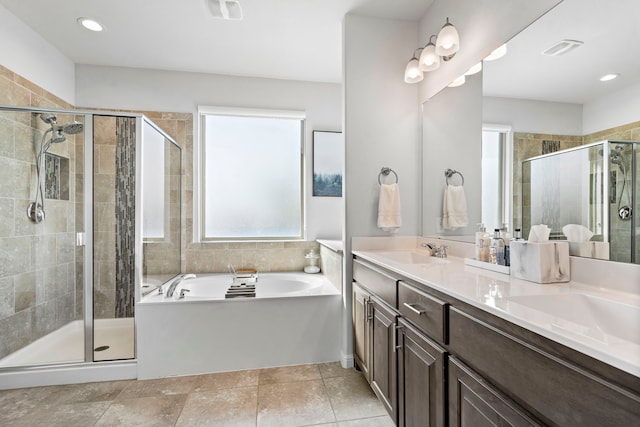 bathroom with independent shower and bath, vanity, and tile patterned flooring