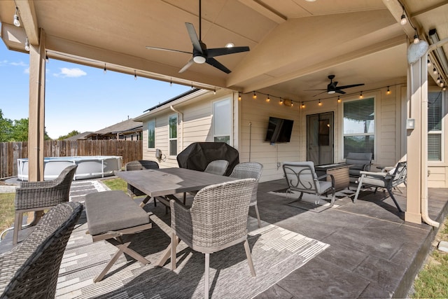 view of patio / terrace with ceiling fan, a hot tub, and grilling area