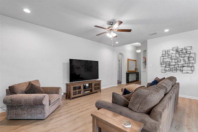 living room featuring ceiling fan and light hardwood / wood-style flooring