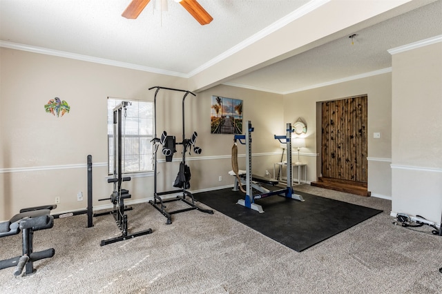 exercise room featuring a textured ceiling, ornamental molding, and carpet