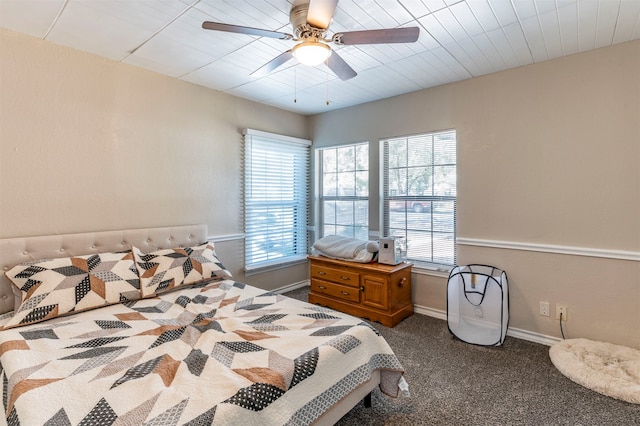 bedroom featuring ceiling fan and dark carpet