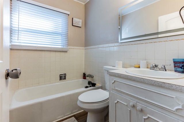 bathroom with a bathing tub, toilet, tile walls, and vanity